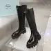 Prada's Sleek Black Knee-High Boots Featuring Glossy Texture and Iconic Logo #B54538
