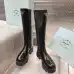 Prada's Sleek Black Knee-High Boots Featuring Glossy Texture and Iconic Logo #B54538