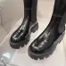 Prada's Sleek Black Knee-High Boots Featuring Glossy Texture and Iconic Logo #B54538