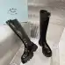 Prada's Sleek Black Knee-High Boots Featuring Glossy Texture and Iconic Logo #B54538