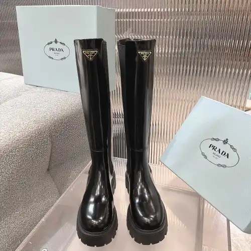 Prada's Sleek Black Knee-High Boots Featuring Glossy Texture and Iconic Logo #B54538